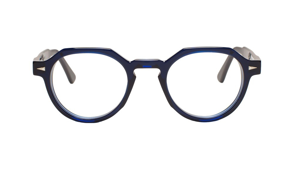 A flat topped, round pair of glasses with thick and bold geometric lines and semi-transparent deep dark blue polished acetate