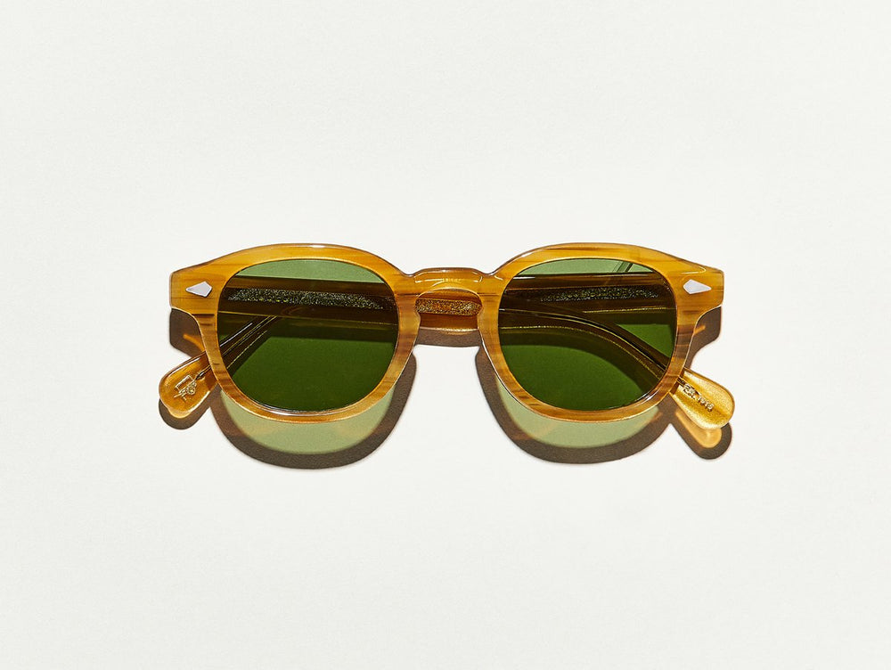 Polished blonde acetate MOSCOT Lemtosh Sunglasses with green glass lenses front view