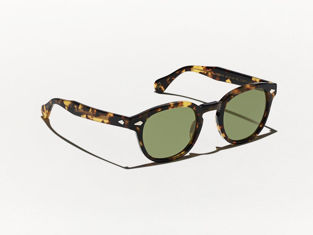 Polished black and yellow tortoiseshell MOSCOT Lemtosh Sunglasses with green glass lenses side view