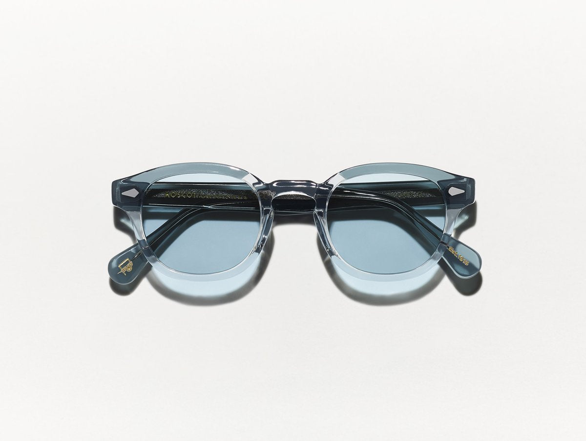 Polished light grey and blue acetate MOSCOT Lemtosh sunglasses with blue glass lenses front view