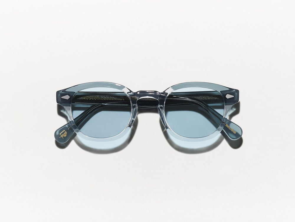 Polished light grey and blue acetate MOSCOT Lemtosh sunglasses with blue glass lenses front view