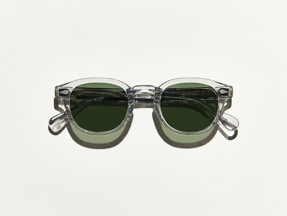 Light grey toned transparent polished acetate MOSCOT Lemtosh sunglasses with green glass sunglass lenses front view 