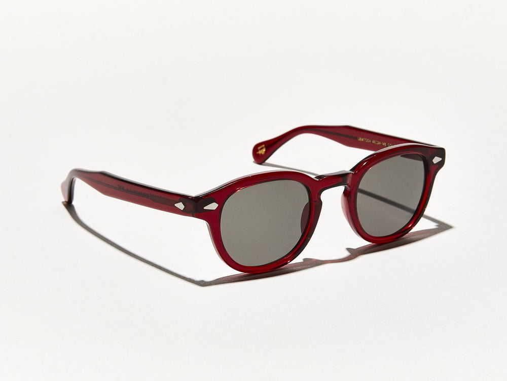 Semi transparent ruby red polished acetate MOSCOT Lemtosh sunglasses with grey glass sunglass lenses side view